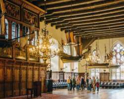 The interior of the upper house shows the importance of trade and commerce for the city. It has a model ship that is hanging on the ceiling. It also h